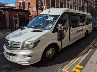 A white Belle Vue minibus